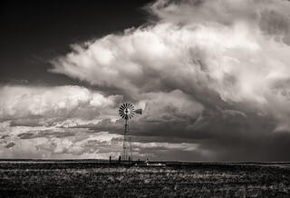Windmill against building clouds